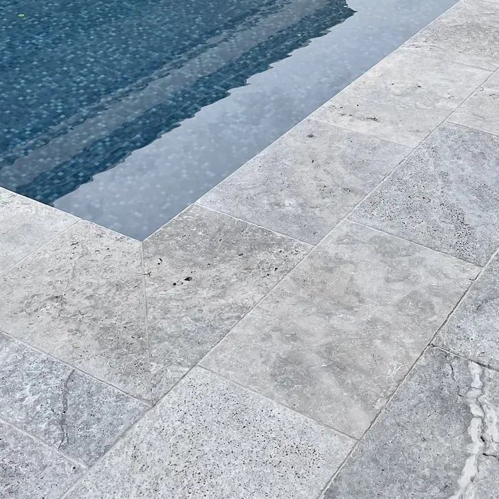Photo d'une terrasse en travertin silver près d'une piscine